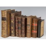 A group of faux books, including a money box, leather bound volumes with cut-out interiors, one