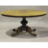 A mid-Victorian rosewood oval tip-top breakfast table, raised on a finely carved base, height