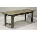 A 17th/18th century oak farmhouse kitchen table, the four-plank top raised on moulded block legs,