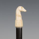 A 19th century ebonized walking cane, the ivory handle finely carved as the head of a greyhound with