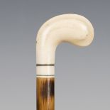 An early 20th century bamboo walking cane, the ivory handle carved as the head of a golf club,