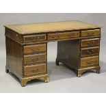 A late 20th century reproduction mahogany twin-pedestal desk with crossbanded decoration, the top