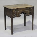 A George III oak lowboy, fitted with three drawers, height 73cm, width 77cm, depth 50cm.Buyer’s