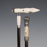A late 19th/early 20th century ebonized walking cane, the ivory and white metal mounted handle