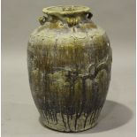 A Chinese stoneware vase of ovoid form with heavy glazed surface and applied relief mouldings,