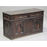 A late 17th/early 18th century oak side cabinet, fitted with a drawer above arched panel doors,