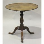 A George III mahogany tip-top wine table, the dished circular top raised on a turned column and