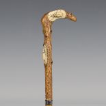 A late 19th century bamboo walking cane, the boxwood handle naturalistically carved as a branch