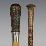 An Art Deco Malacca walking cane with a carved foliate softwood handle above a silver collar, length