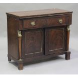 A French Empire figured mahogany chiffonier, fitted with a drawer above a cupboard, on block feet,