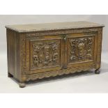 A late 19th century Spanish oak sideboard, the two doors carved in high relief with portrait