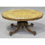 A late Victorian burr walnut and foliate inlaid oval coffee table, raised on four downswept