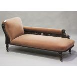 A Victorian carved oak framed chaise longue, upholstered in pink velour, on turned legs and castors,