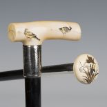 A late 19th century ebonized walking cane, the Japanese carved ivory handle inset with three