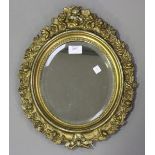 A Victorian oval giltwood and gesso wall mirror with overall foliate decoration, 41cm x 33cm.Buyer’s