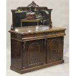 A late Victorian mahogany side cabinet, the mirror back above a pair of cushion frieze drawers and