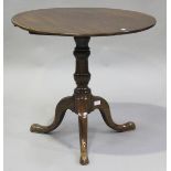 A late George III mahogany circular tip-top wine table, raised on tripod legs, height 68cm, diameter
