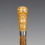 An early 18th century Malacca walking cane, the ivory handle with silver piqué inlaid decoration