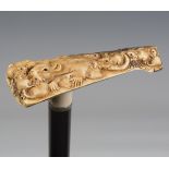 A late Victorian ebonized walking cane, the Japanese ivory handle finely carved with a mother rat