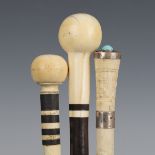 An early 20th century rosewood walking cane with an ivory bulbous handle, length 88cm, together with