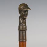 A late 19th/early 20th century Malacca walking cane, the cast bronze handle modelled as the head