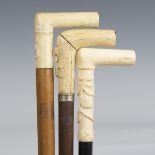 A late 19th century ebonized walking cane, the ivory handle carved with oak leaves and an acorn,