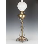 A late Victorian brass and copper mounted table oil lamp with adjustable stem and opaline glass