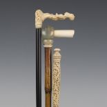 A 19th century ebonized walking cane, the Chinese carved ivory handle profusely worked with