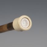An early 20th century hickory walking cane, the ivory handle fitted with a timepiece above a