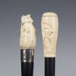 A late 19th/early 20th century ebonized walking cane, the ivory handle carved with two elephants,