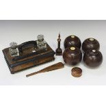 A group of four late 19th century hardwood bowling bowls, a Victorian walnut inkstand, a Mauchline