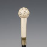 An early 20th century ebonized walking cane, the ivory handle finely engraved with Masonic emblems