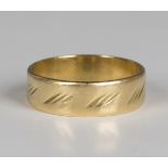An 18ct gold wedding band with engraved decoration, weight 5g, ring size approx T1/2.Buyer’s Premium