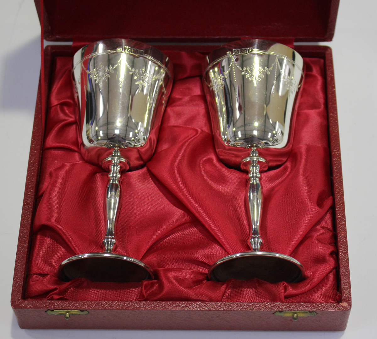 A pair of Elizabeth II silver goblets, each gilt-lined tapered bowl engraved with floral garlands, - Image 2 of 3