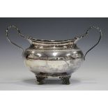 A George V silver two-handled circular sugar bowl with egg and dart rim and foliate capped scroll