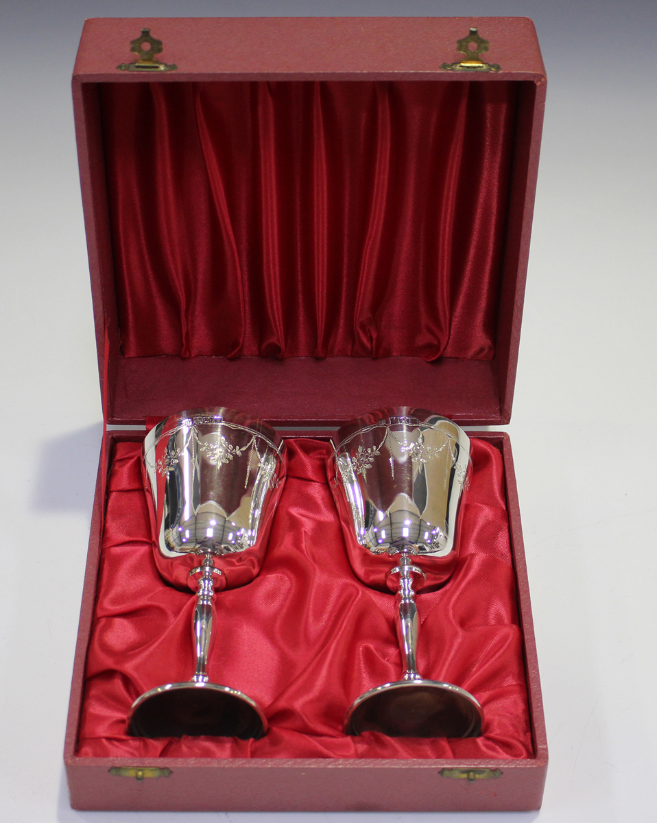 A pair of Elizabeth II silver goblets, each gilt-lined tapered bowl engraved with floral garlands, - Image 2 of 3