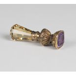 A faceted citrine and amethyst seal, circa 1830, the amethyst intaglio engraved with a shield,