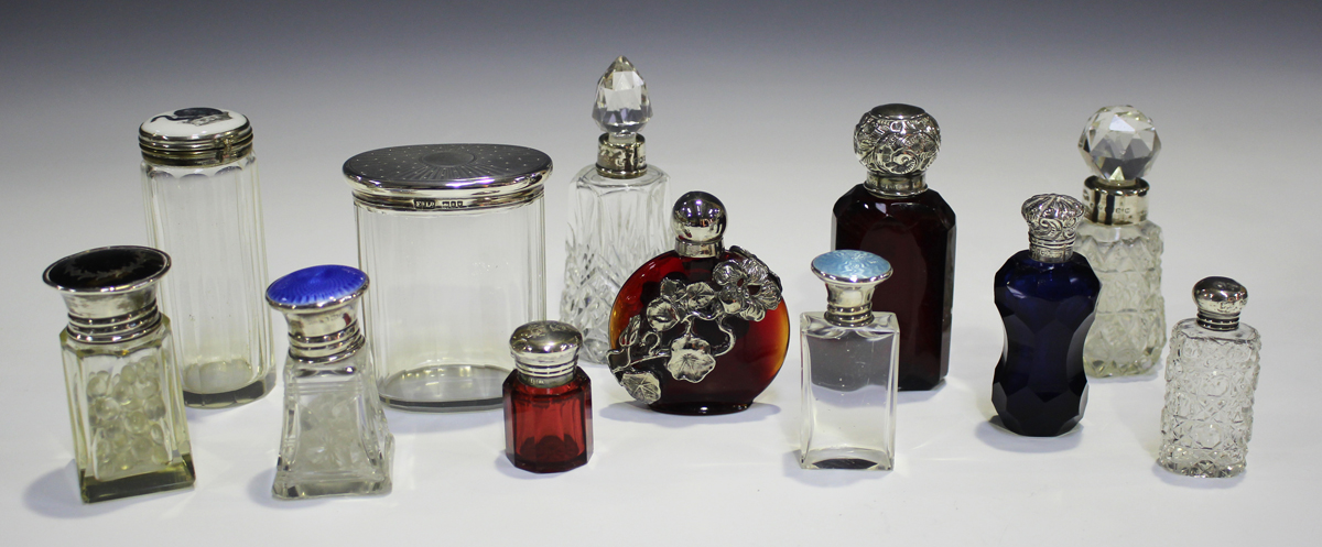 An Edwardian silver mounted ruby glass scent bottle and stopper, the faceted body beneath a