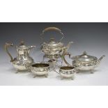 An Edwardian silver five-piece tea set, each piece of circular form with shaped rim, comprising