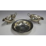 A pair of Edwardian silver sauceboats, with foliate capped scroll handles, London 1906 by Mappin &