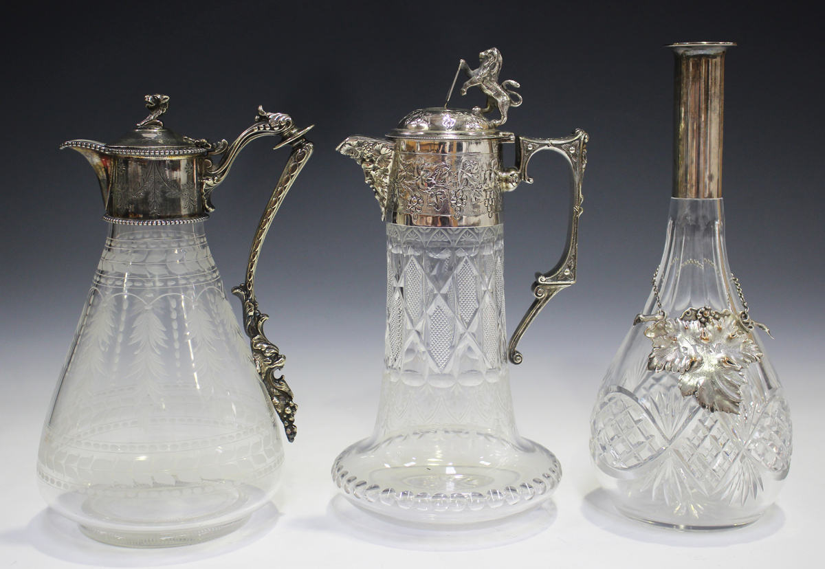 A late 19th/early 20th century cut glass and silver plated claret jug, the cylindrical body cut with