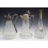 A late 19th/early 20th century cut glass and silver plated claret jug, the cylindrical body cut with