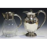A 19th century Sheffield plate hot water jug, the ovoid body with foliate capped handle, on a