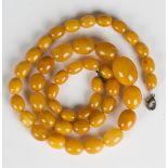 A single row necklace of forty-five graduated oval vari-coloured opaque and semi-translucent light