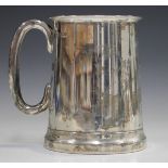 A George VI silver tankard of tapered cylindrical form with glass panelled base and loop handle,