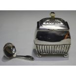 A late Victorian silver tea caddy of half-reeded rectangular form with button feet and ivory finial,