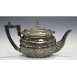A late Victorian silver bachelor's teapot of oval form with half-reeded decoration, London 1895 by