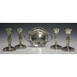 A set of four Elizabeth II silver stub candlesticks with swollen stems and circular bases,