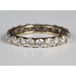 A gold and cubic zirconia eternity ring, mounted with circular cut cubic zirconia, detailed '14K