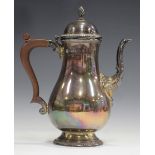 An Elizabeth II silver coffee pot of baluster form with domed hinged lid and foliate moulded